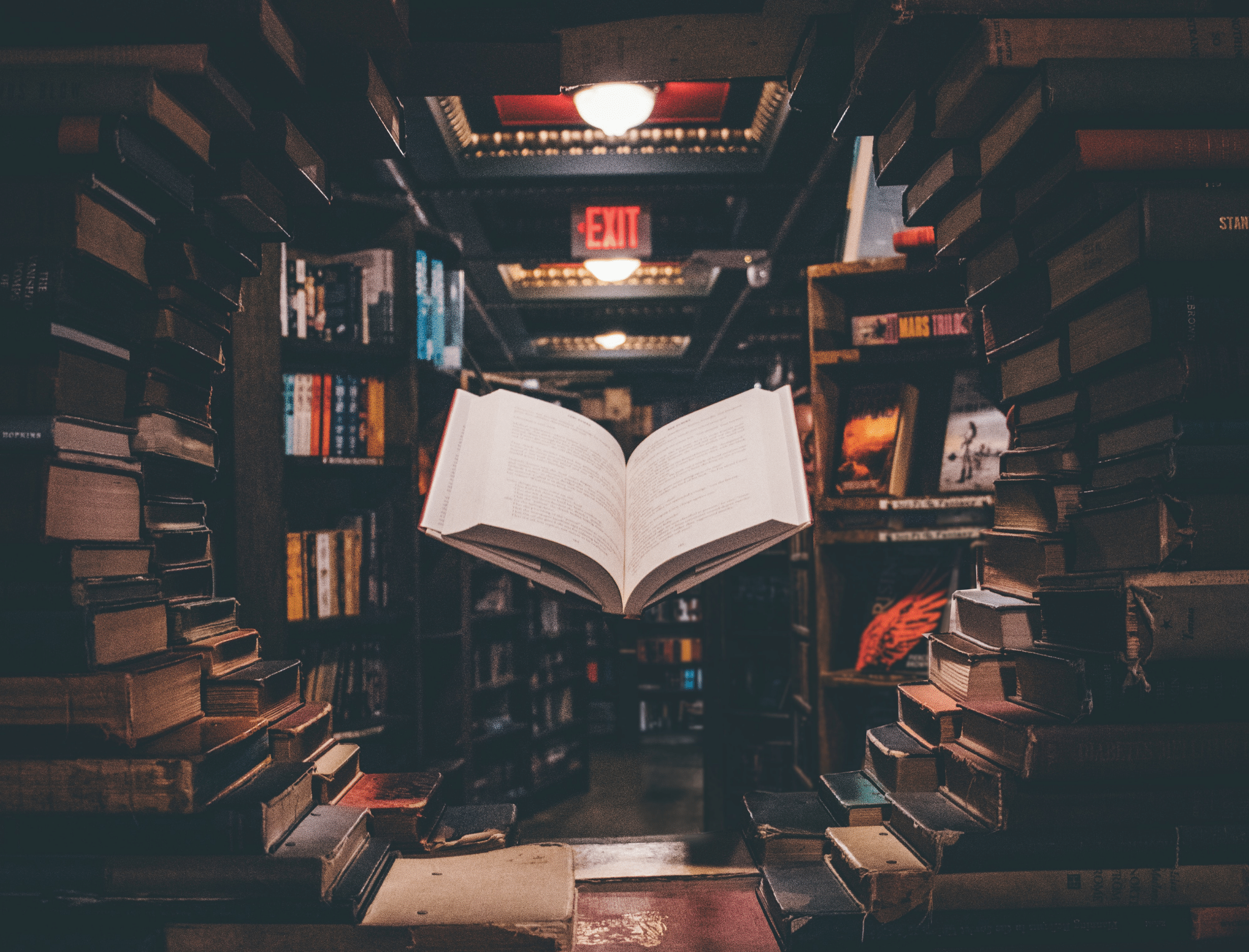Book floating amidst stacks of books. Learn about crowdfunding for authors with Publish Your Purpose.