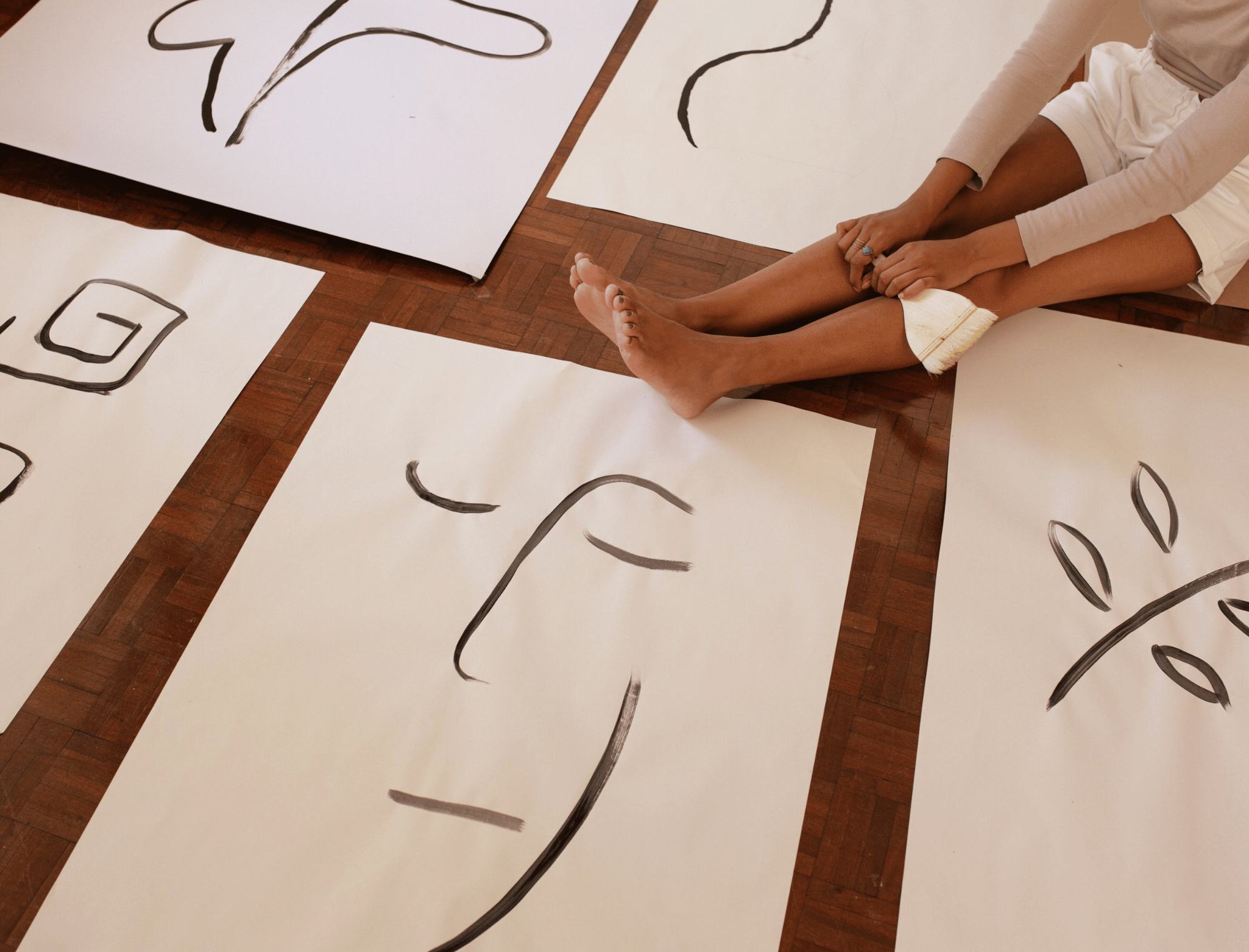 Woman sitting with illustrations. Learn the habits of famous writers with Publish Your Purpose.