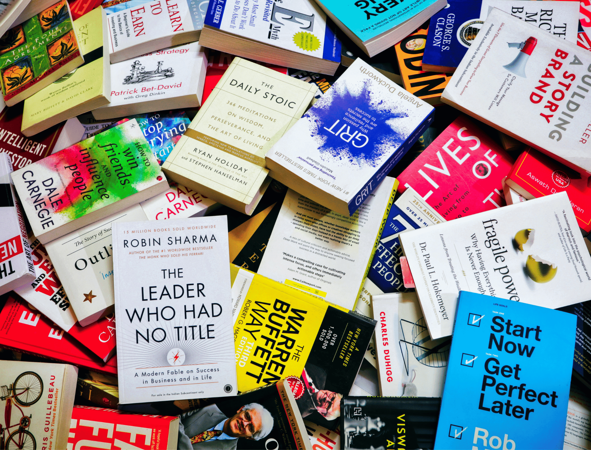 A pile of non-fiction books. Learn about non-fiction publishing with Publish Your Purpose.