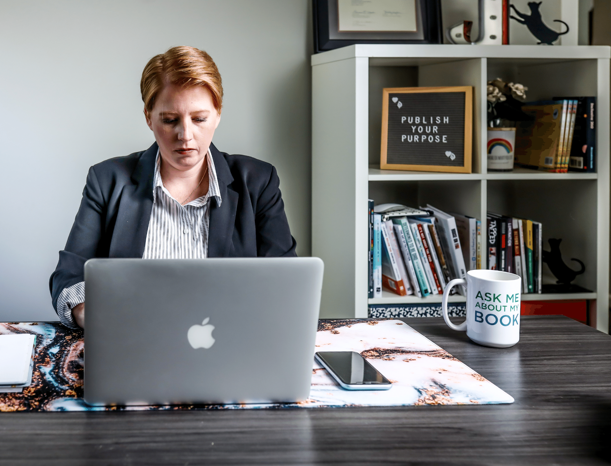 Jenn T. Grace typing on laptop. Here’s why publishing strategists are important for non-fiction writers.